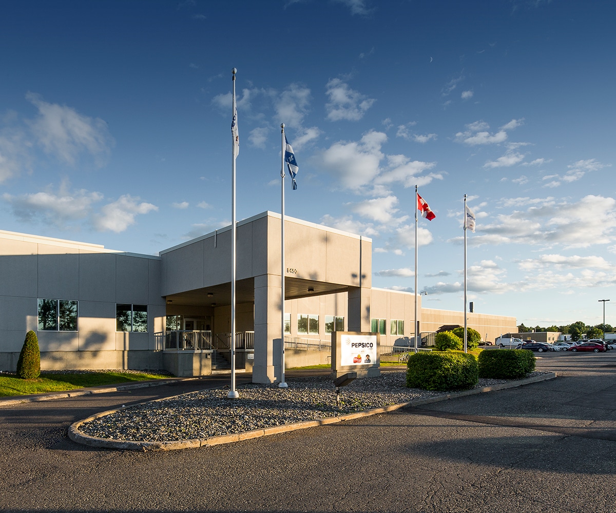 A PepsiCo building with several flags outside.