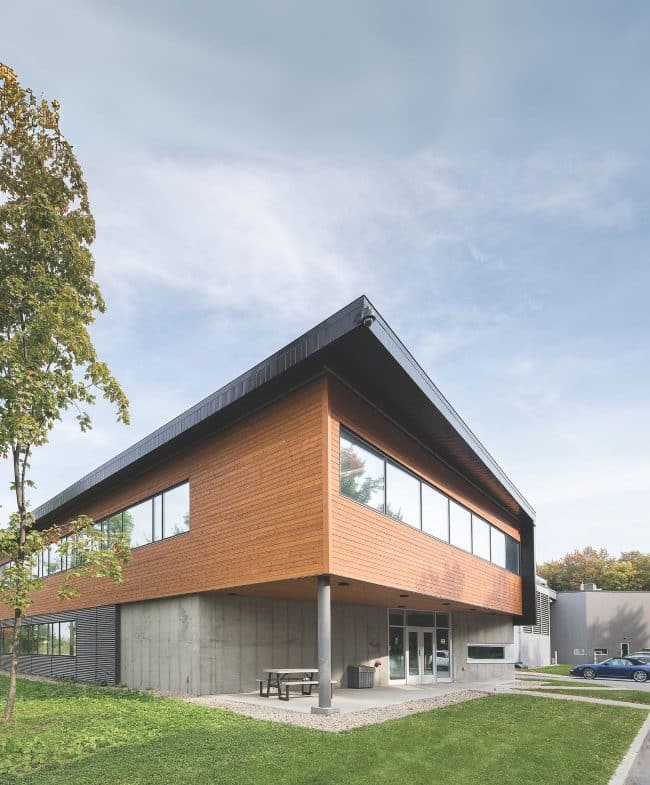 Un bâtiment moderne avec un revêtement en bois et de grandes fenêtres.